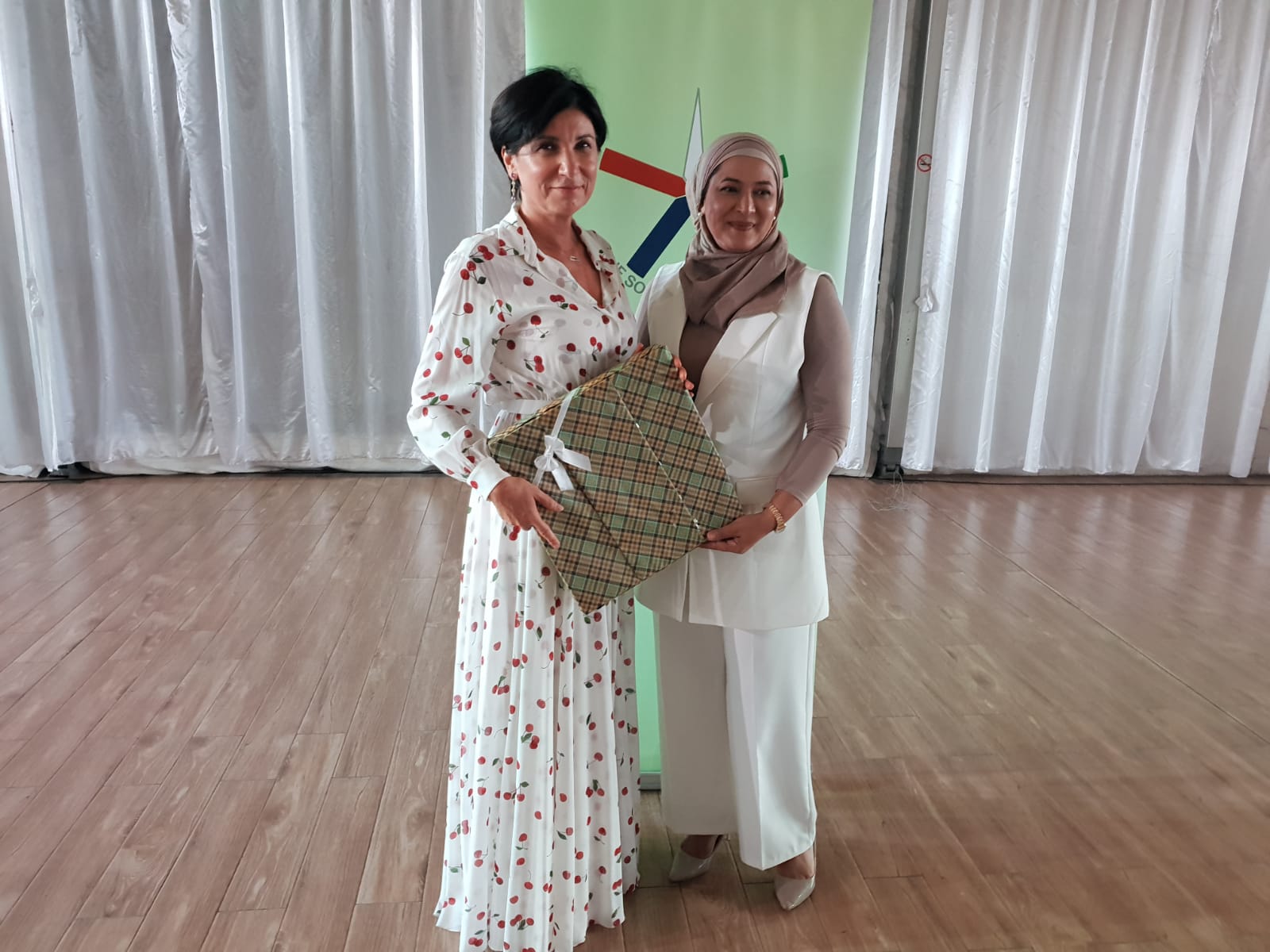 Ambassador receiving a present from Secretary Tanzila